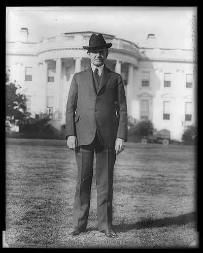 [President Coolidge, full-length portrait, standing on south lawn of White House, facing front]