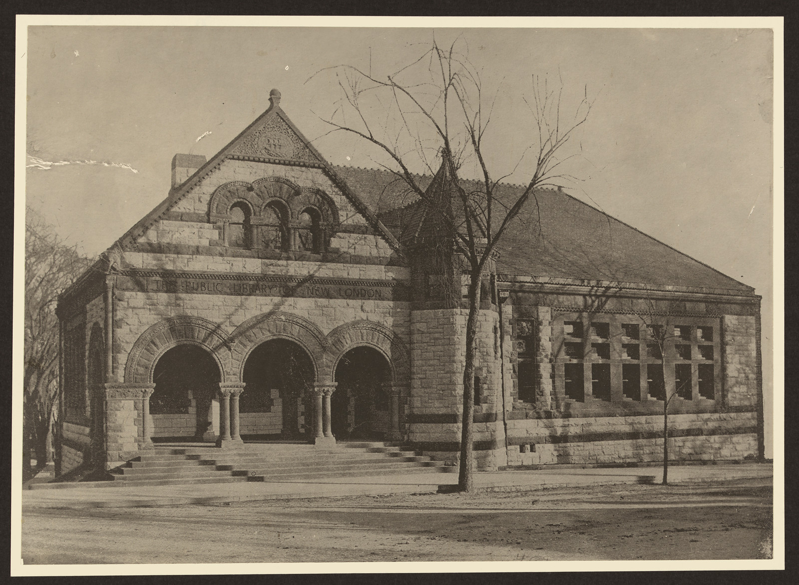 Stone Romanesque public library building with arched entrances — historic image