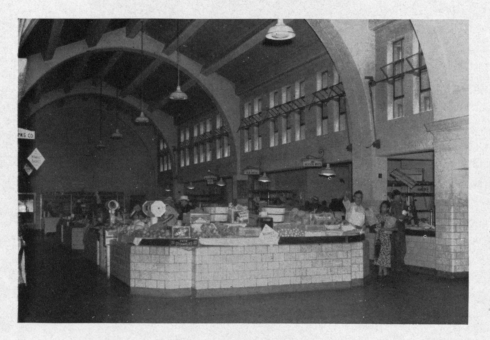 Interior of a market hall with produce stalls — historic image