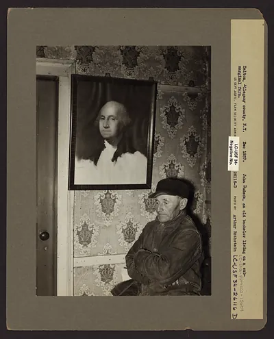 John Dudeck, an old bachelor, beside a Washington portrait
