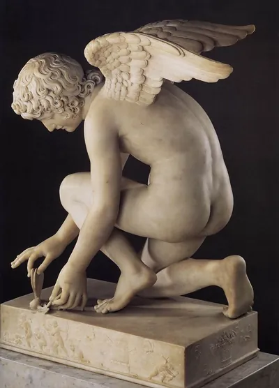 Marble statue of a kneeling winged Cupid on a relief pedestal