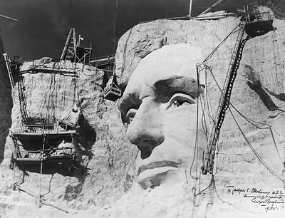 Carving of Abraham Lincoln's face on Mount Rushmore under construction