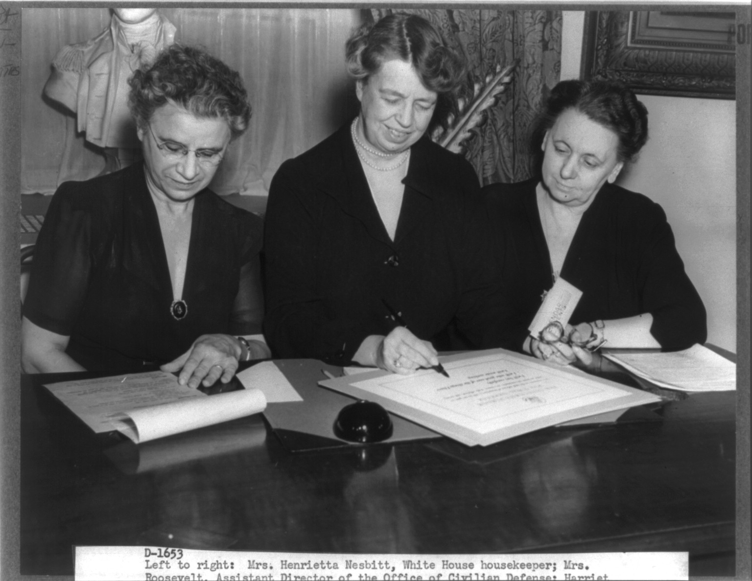 [Eleanor Roosevelt, 1884-1962, half-length portrait, seated at desk, between Mrs. Henrietta Nesbitt, White House housekeeper, and Harriet Elliott, Assoc. Administrator in charge of the Consumer Div., Office of Price Administration] — historic photograph