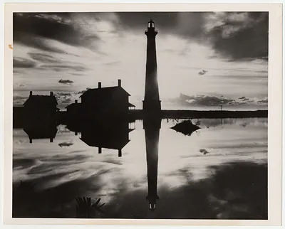 Historic old lighthouse mirrored in a pool