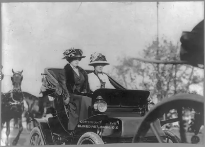 [Mrs. Alice (Roosevelt) Longworth, 1884-, driving auto, with friend]