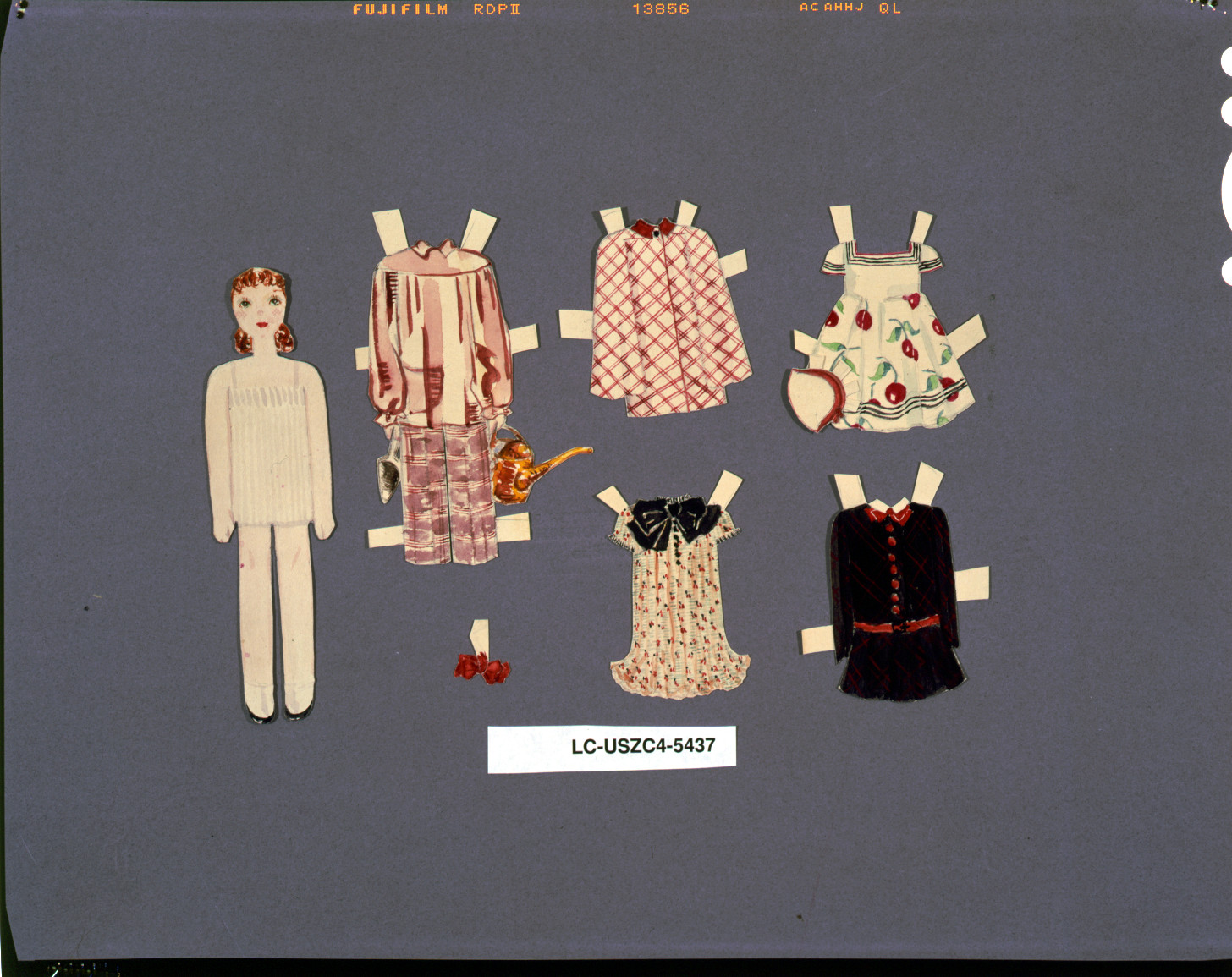 Paper doll with cut-out clothing outfits on gray background — historic image