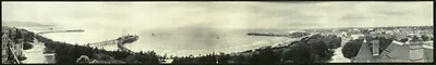 Panoramic view of coastline with piers and town