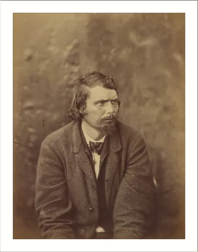 Sepia portrait of a bearded man in a coat