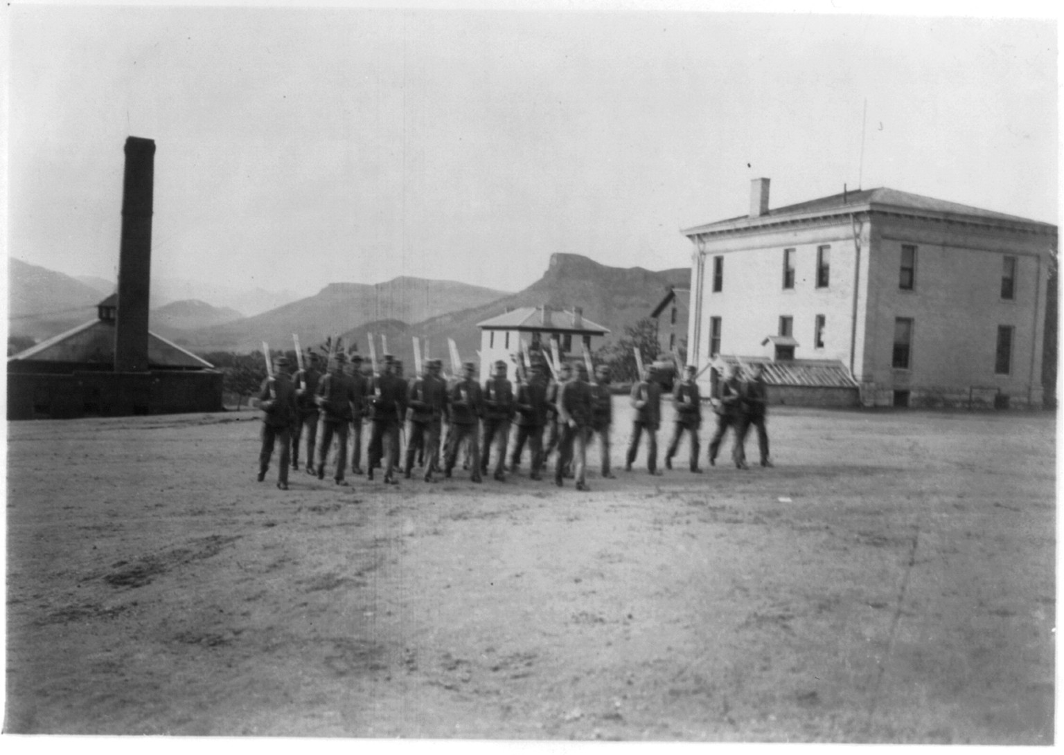 [Boys at drill (marching), Golden Industrial School, Denver, Colorado: Boys marching toward camera], [between 1910 and 1915(?)] — historic photograph