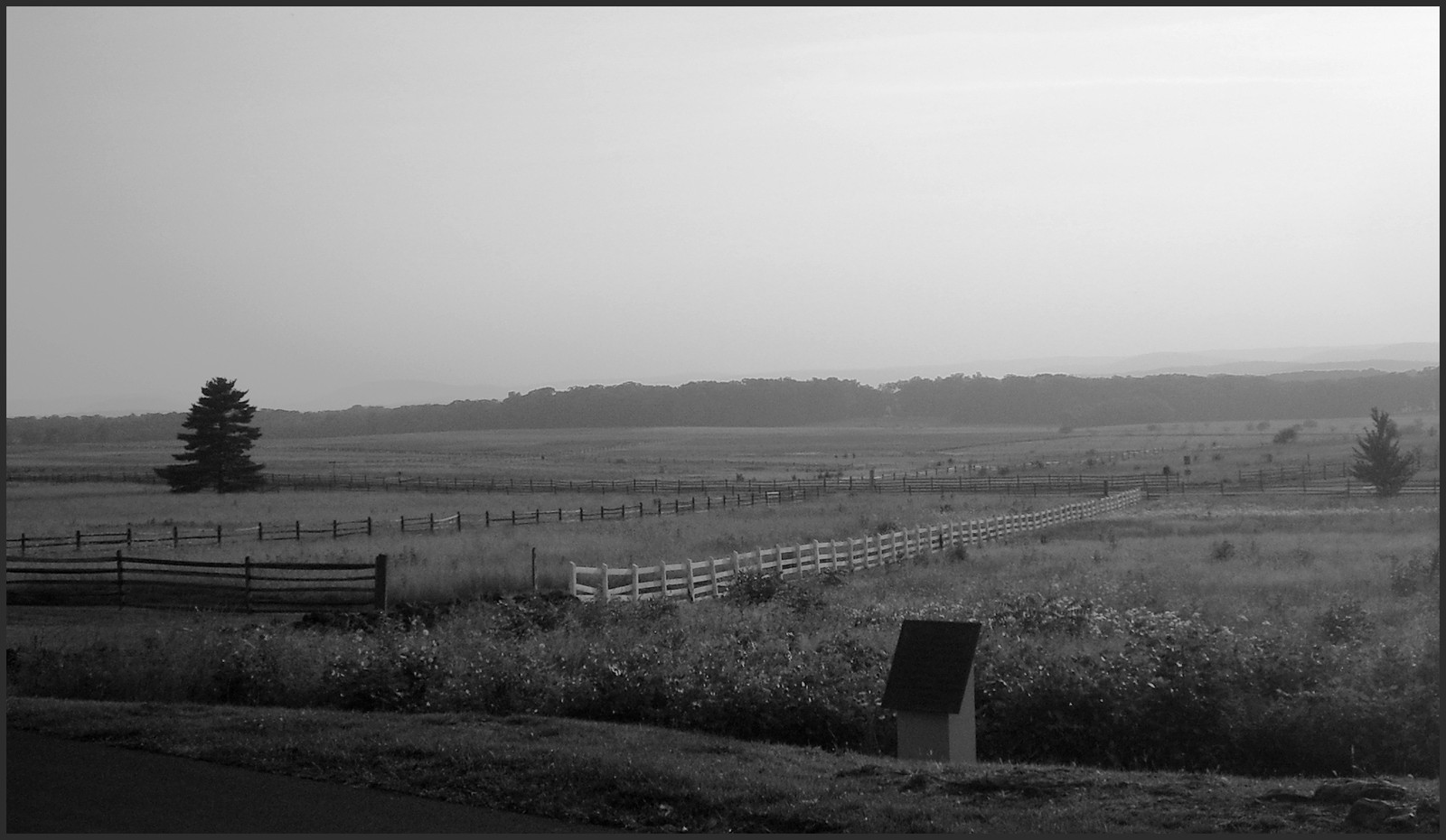 Rolling battlefield fields with split-rail and white fences — historic image