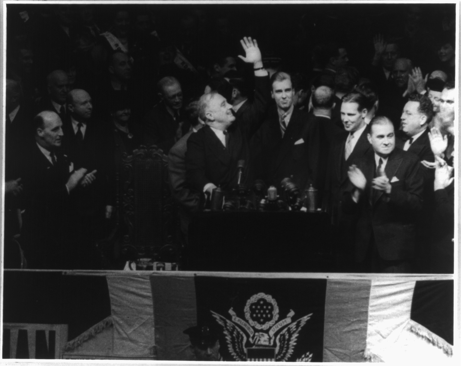 [Franklin Delano Roosevelt, 1882-1945; half length, right profile, waving from speaker's podium] — historic photograph
