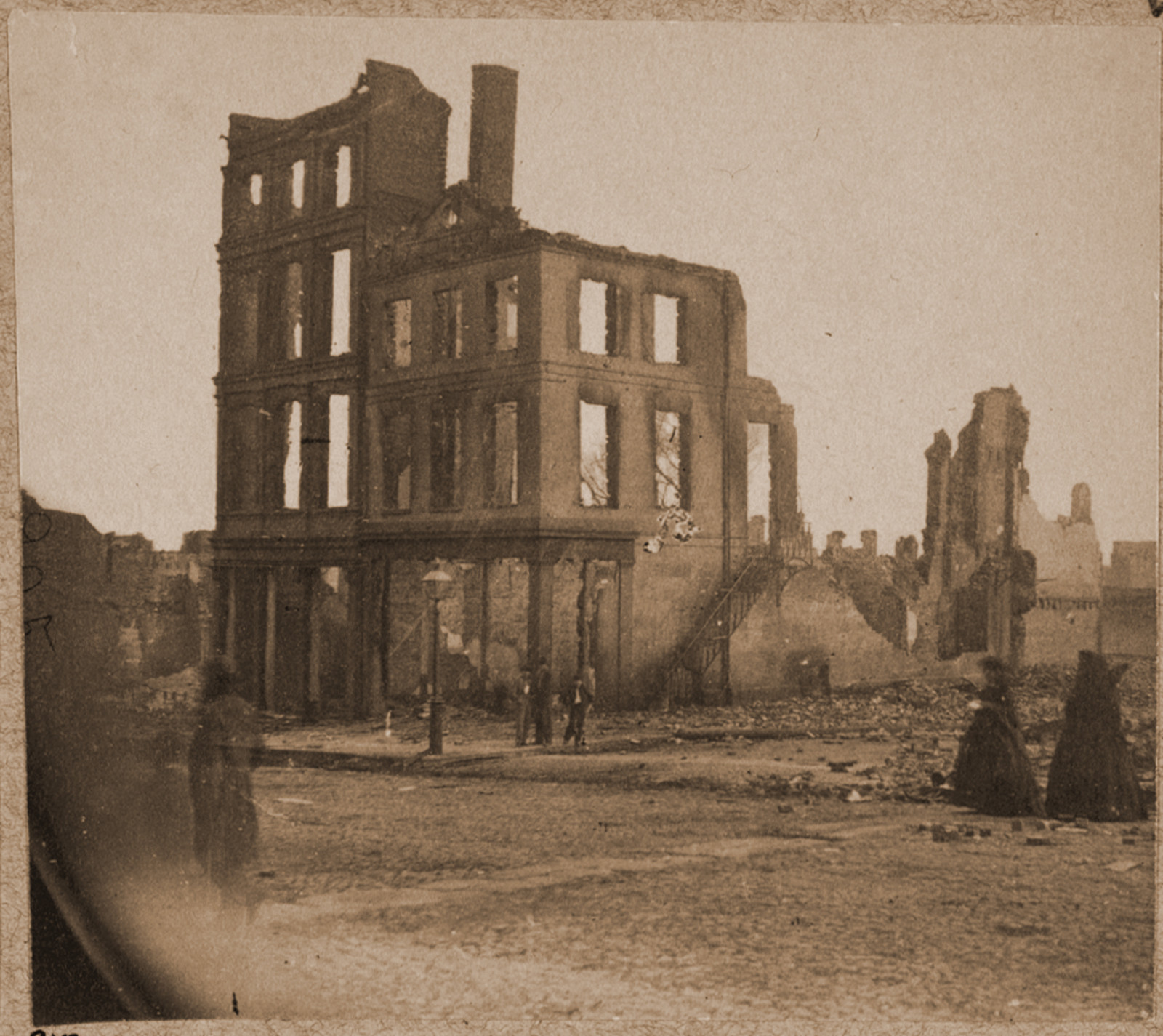 View in the Burnt District Richmond Va. showing two women dressed in black approach, 1865 — historic photograph