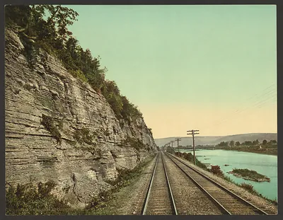 Rock palisades beside railway tracks and river