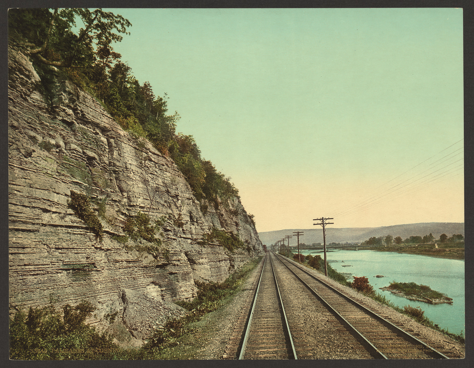 Rock palisades beside railway tracks and river — historic image