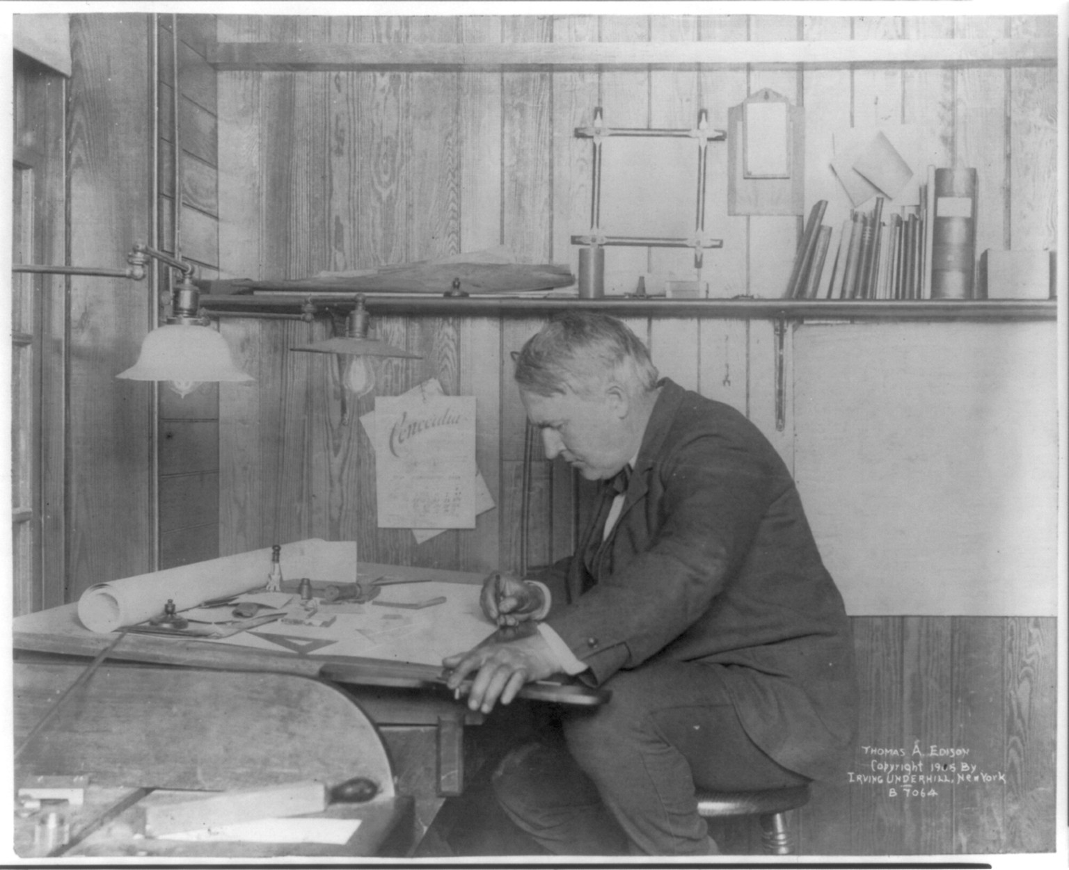 [Thomas Alva Edison, 1847-1931, left profile, seated at his desk, writing], c1905. — historic photograph
