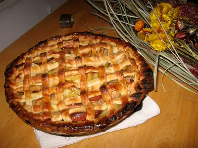 Lattice-topped apple pie on a wooden table