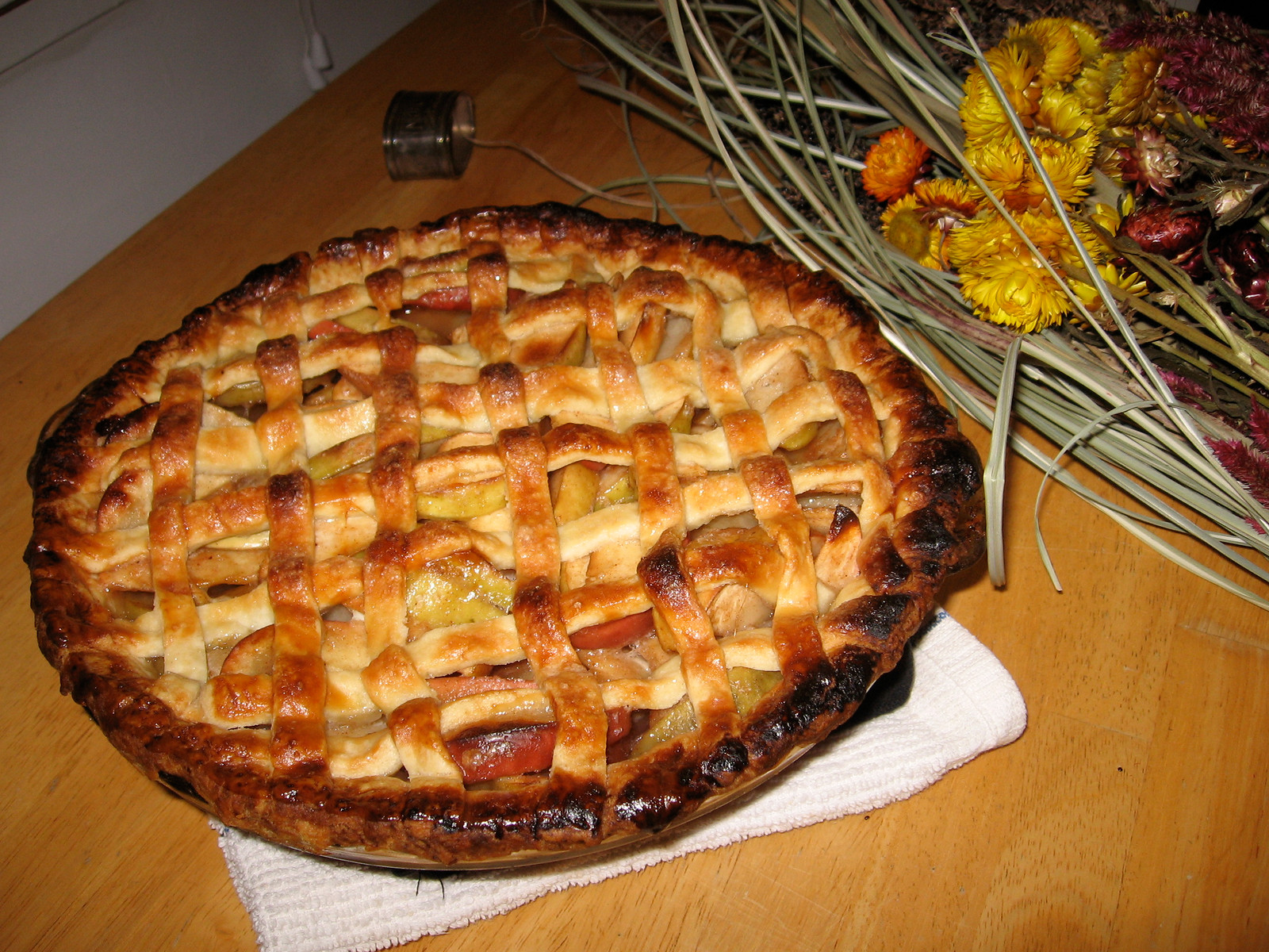 Lattice-topped apple pie on a wooden table, 1899 — historic image