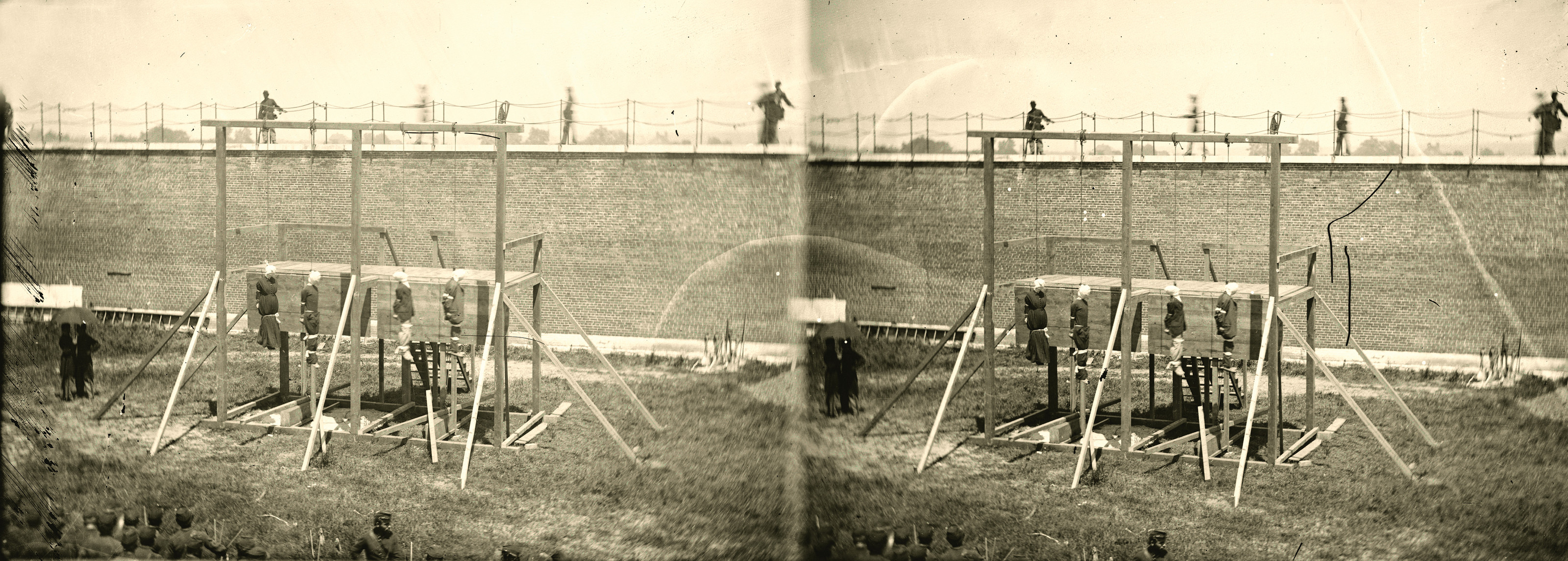 Gallows with four nooses in a walled yard, stereo photograph — historic photograph