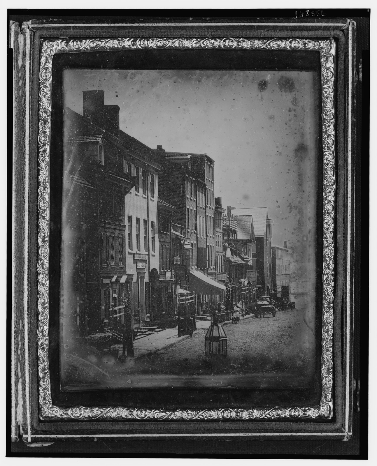 Daguerreotype street scene with brick buildings and a horse cart, 1842 — historic photograph