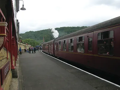 Maroon passenger train at a steam railway platform