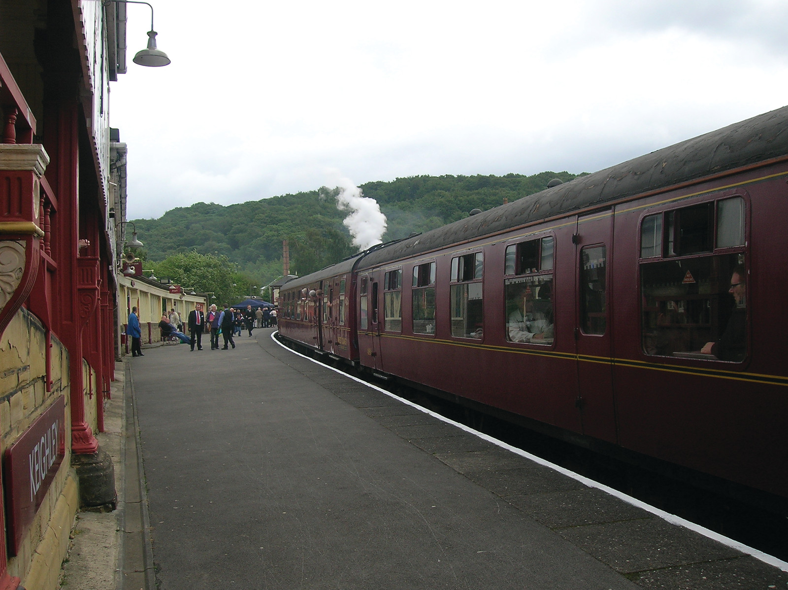 Maroon passenger train at a steam railway platform — historic image