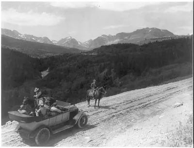 [Mont. - Glacier National Park - looking up the valley of the Swift Current River from auto. road." White auto in foreground]"