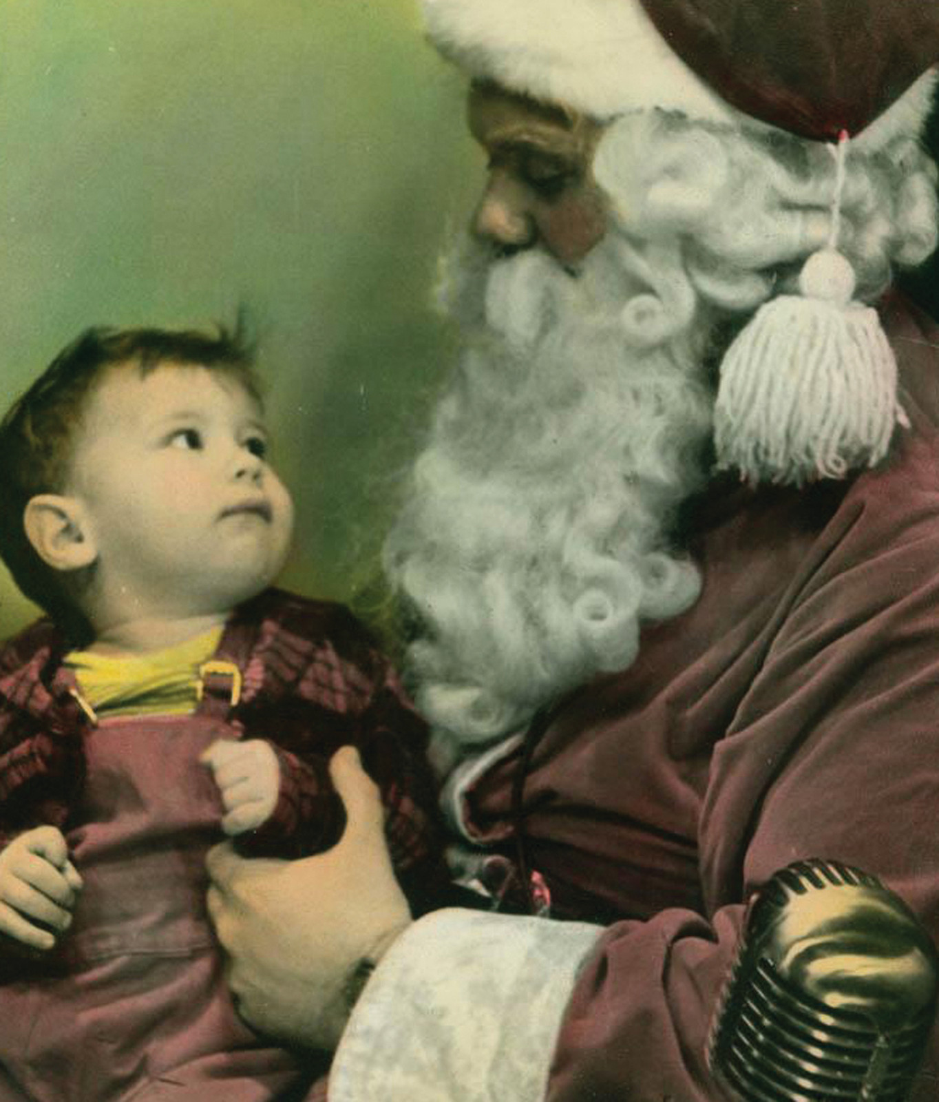 Santa Claus holding a toddler, hand-colored photograph — historic photograph