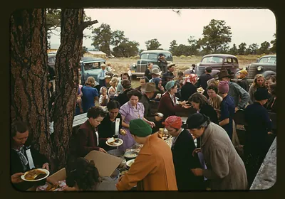 Women serving food at an outdoor fair picnic
