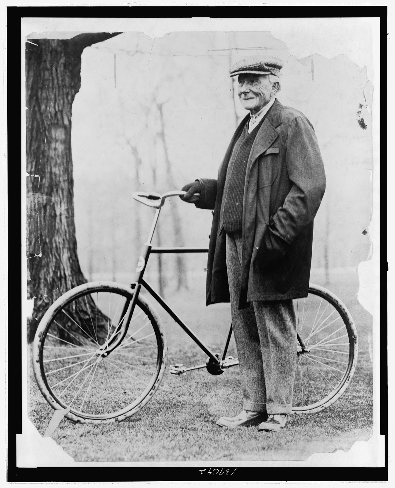 [John D. Rockefeller, full-length portrait, standing with a bicycle], 1913 — historic photograph
