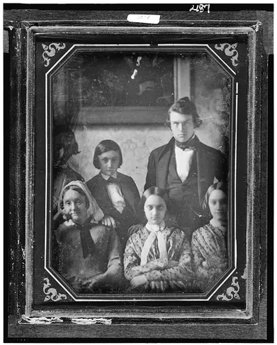[Members of the Cresson and Prichett families, with three seated women in front and two men and a boy in the back, standing in front of a framed picture or mirror]