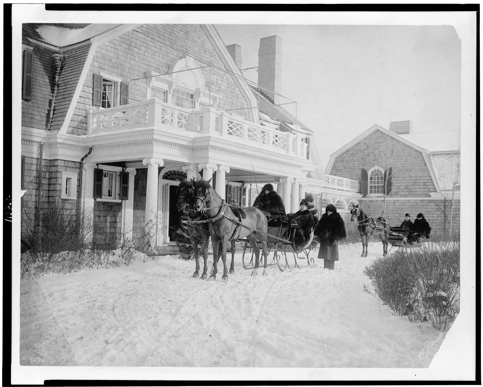 [Horse-drawn sleighs with passengers in front of house], c1904. — historic photograph