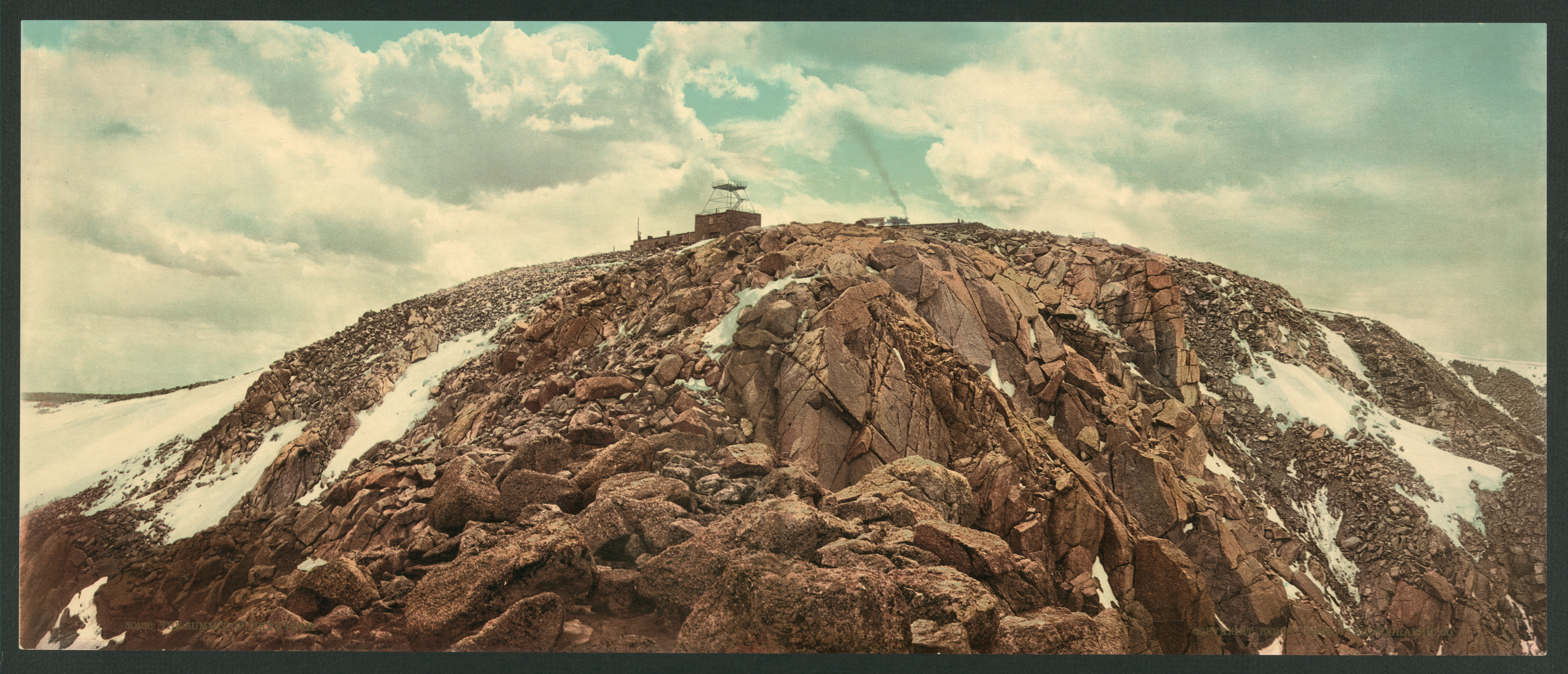 Rocky mountain summit with a small building and snow — historic image