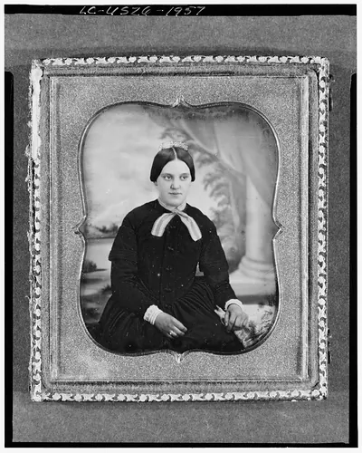 Unidentified woman, seated portrait in ornate daguerreotype case