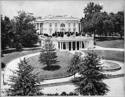 [White House from State, War & Navy bldg., showing West wing, gardens, and fountain]