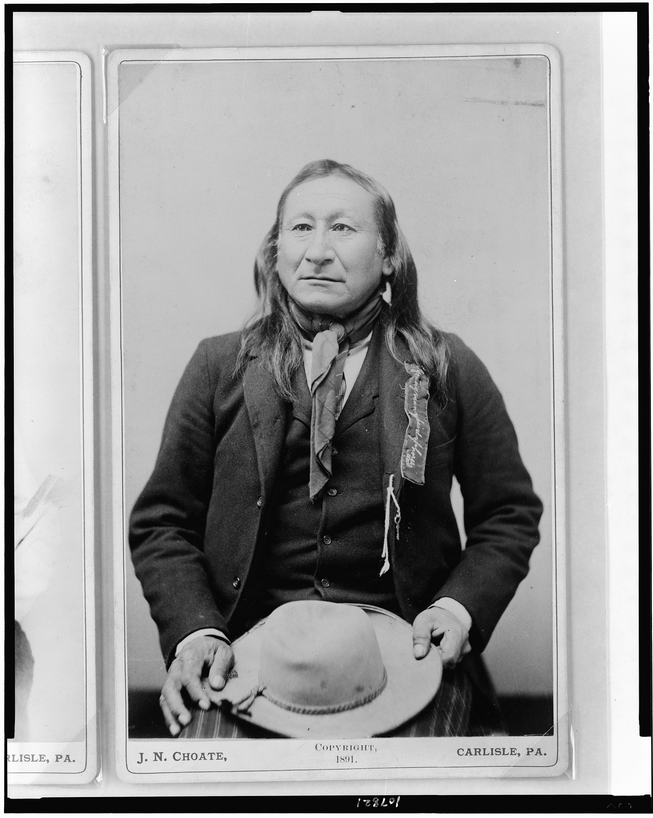 [Young Man Afraid of His Horses, half-length portrait, seated, facing slightly left, holding hat] / J.N. Choate, Carlisle, Pa., c1891. — historic photograph