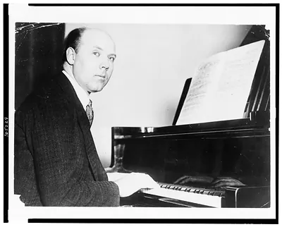 [Walter Gieseking, half-length portrait, seated at piano, facing right]
