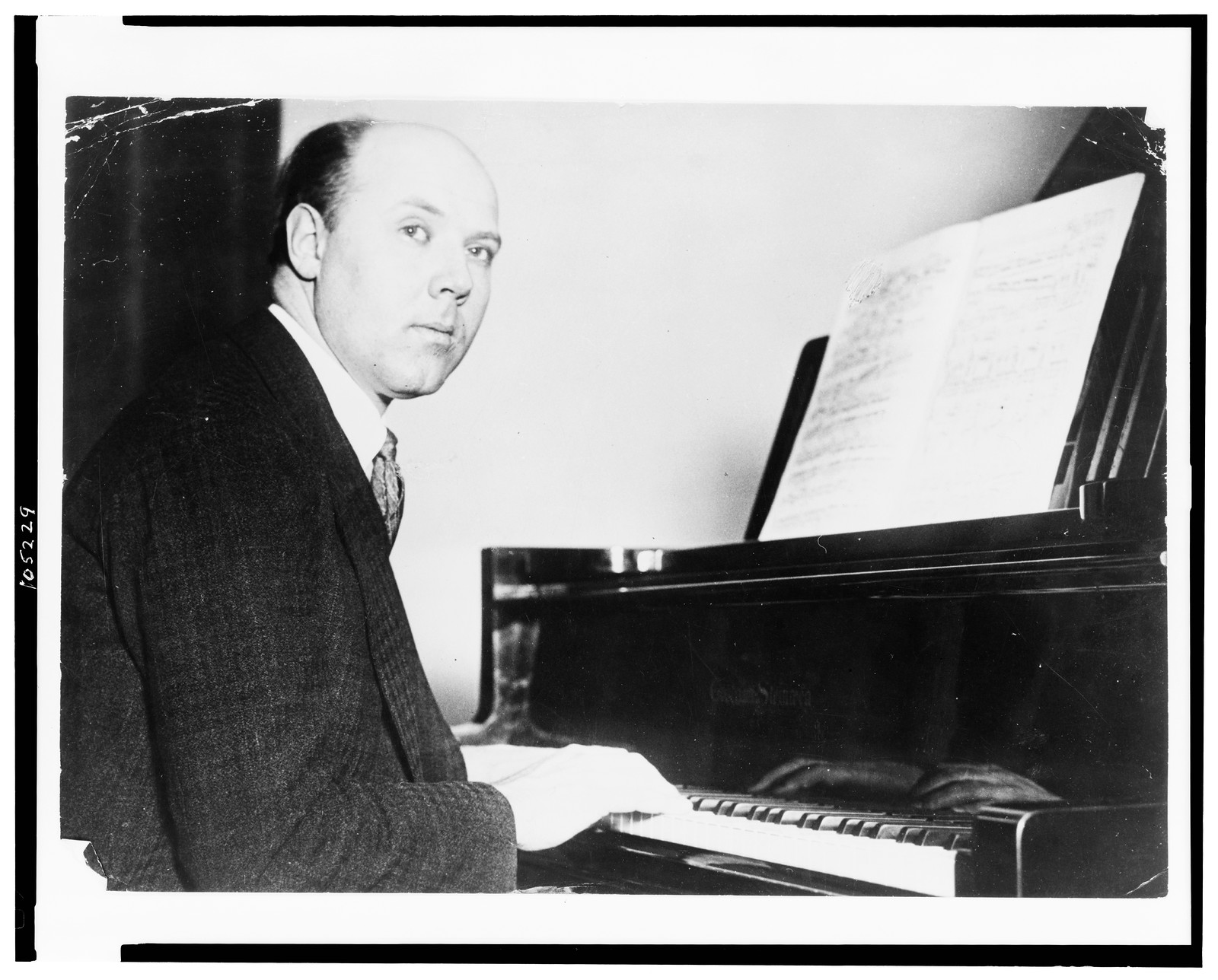 [Walter Gieseking, half-length portrait, seated at piano, facing right], [between 1926 and 1944] — historic photograph