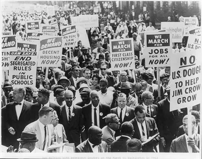 [Roy Wilkins with a few of the 250,000 participants on the Mall heading for the Lincoln Memorial in the NAACP march on Washington on August 28, 1963]