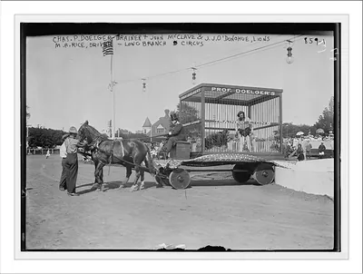 Horse-drawn lion cage of trainer Chas. P. Doelger and lions, driver M.A. Rice, Society Circus, Long Branch