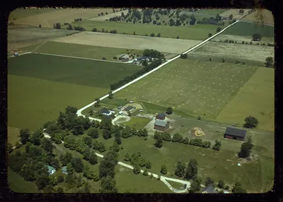 Aerial view of farmland with farm buildings and country roads