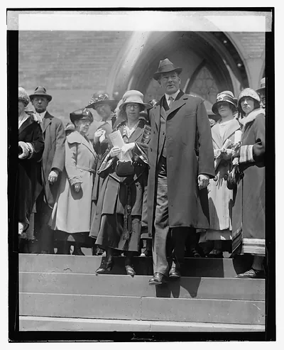 Secty. & Mrs. Wilbur leaving church, 4/21/24