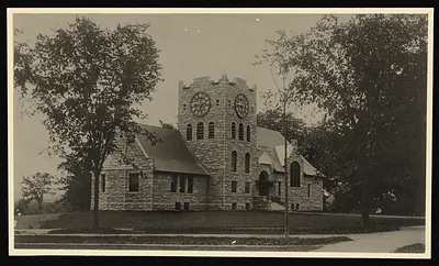 Stone building with clock tower, sepia photograph
