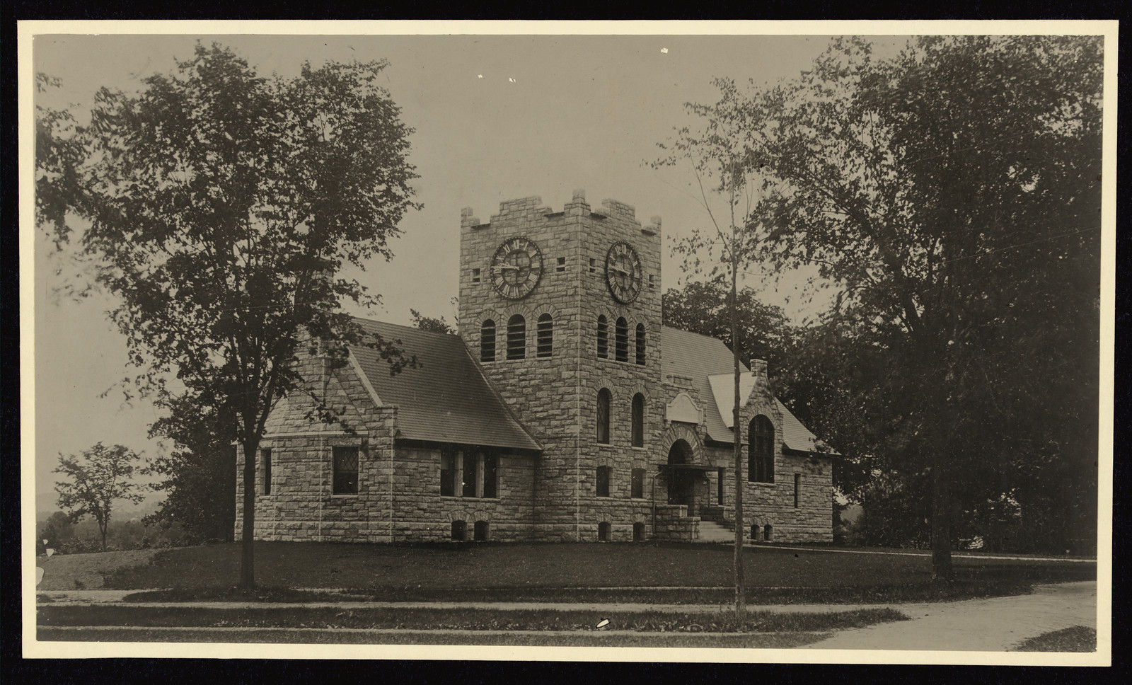 Stone building with clock tower, sepia photograph — historic photograph