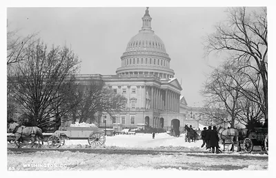 Snowy Capitol dome with horse-drawn sleighs and wagons