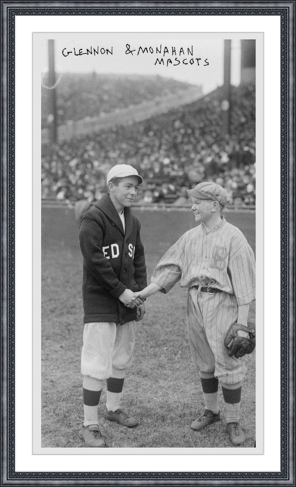 Glennon and Monahan mascots shaking hands at ballpark — historic image