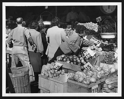 Shoppers selecting produce at a market stall