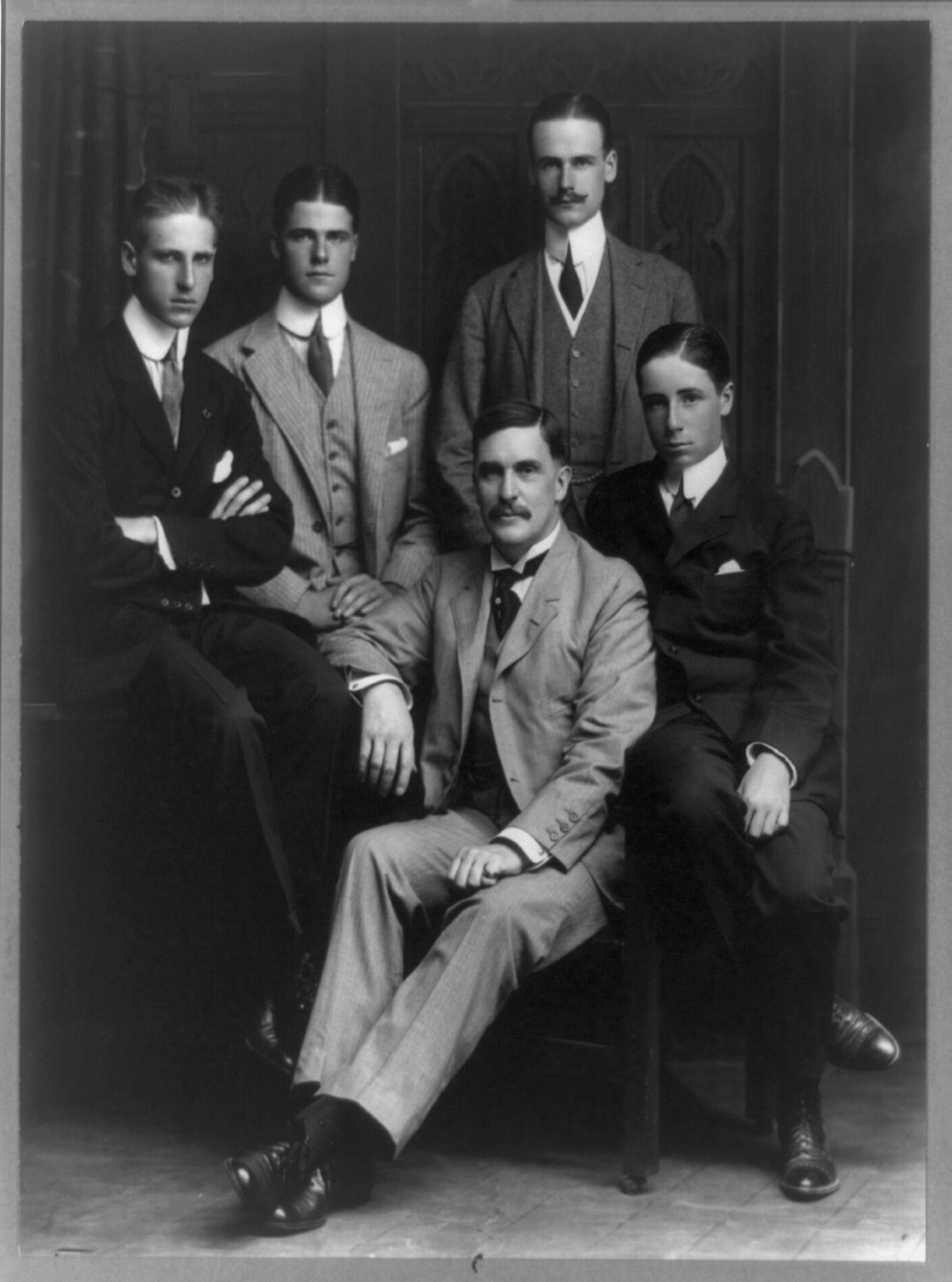 [Thomas Mott Osborne, full-length portrait, seated, facing left, and his four sons], c1910. — historic photograph