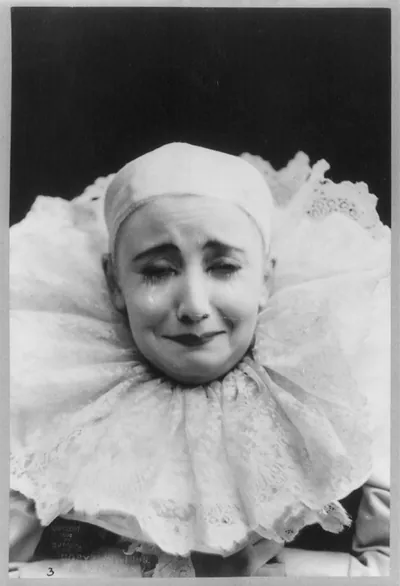 Pilar Morin as clown/mime: head and shoulders, facing front; crying