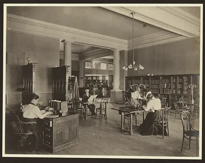 Adult reading room in a library with long wooden tables