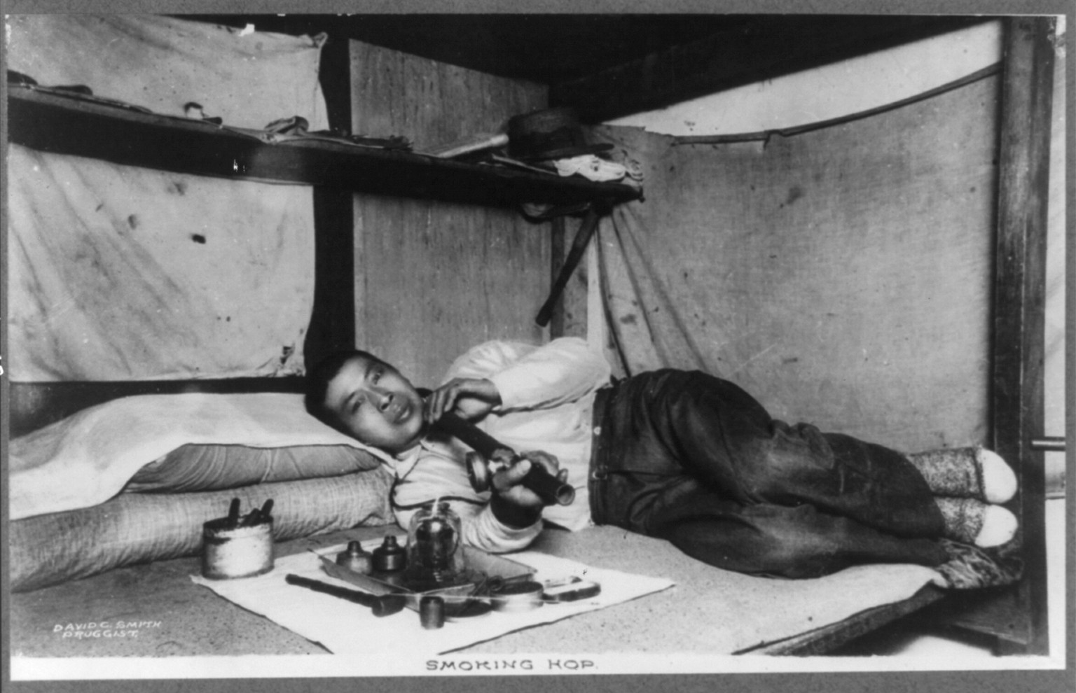 [Montana - Missoula - Asian man smoking hop in a bunk], [no date recorded on caption card] — historic photograph